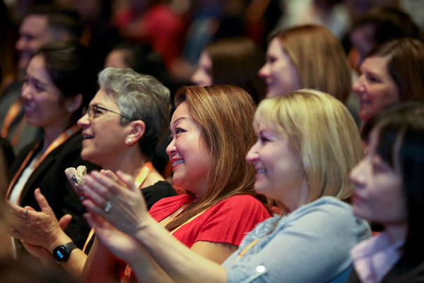 members clapping at event